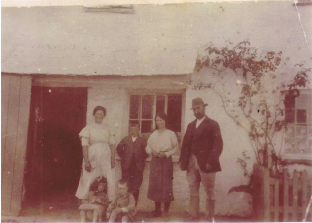 Archive photograph of the family outside the farmhouse