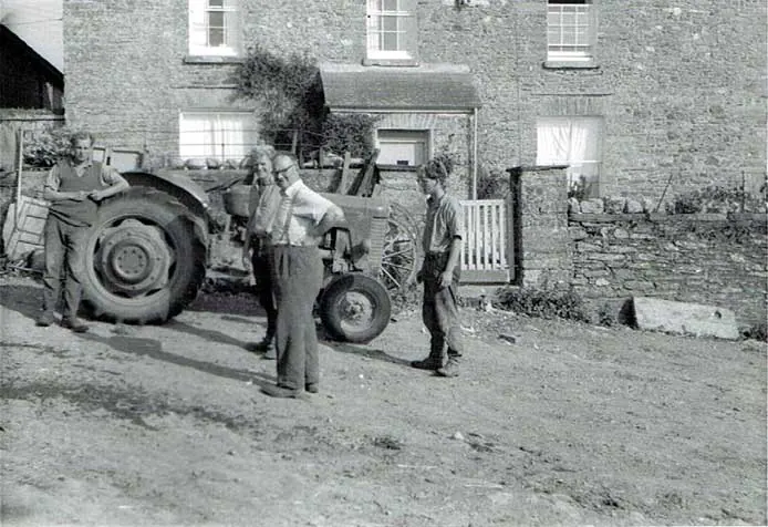 Archive photograph of farmers with an early tractor