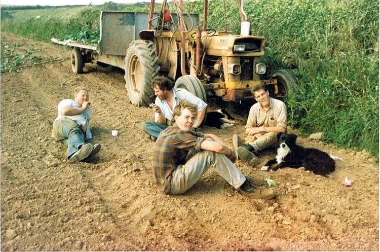 Archive photograph of the family beside a tractor in a field