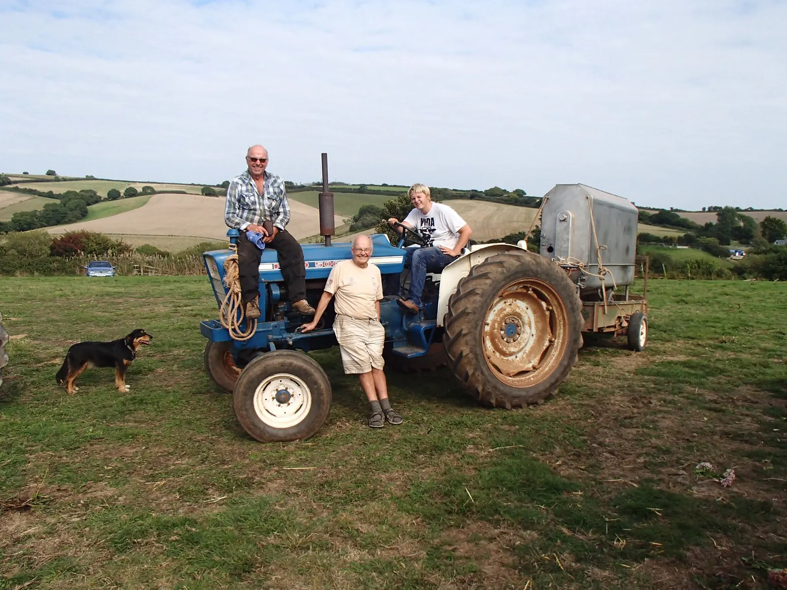 Three generations of the family with a tractor in the field