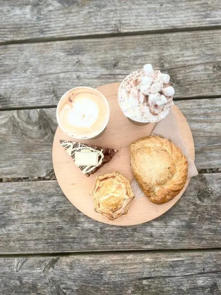 Coffee, a pie and a sweet treat on a wooden board